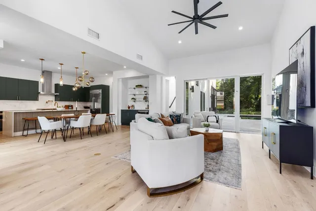 a white painted house with a potted plant