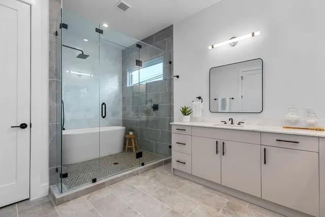 a bedroom with a large bed and a couch