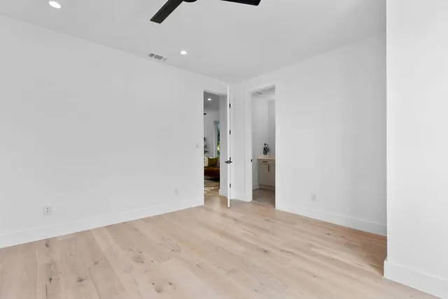 a spacious bathroom with a double vanity sink and a mirror