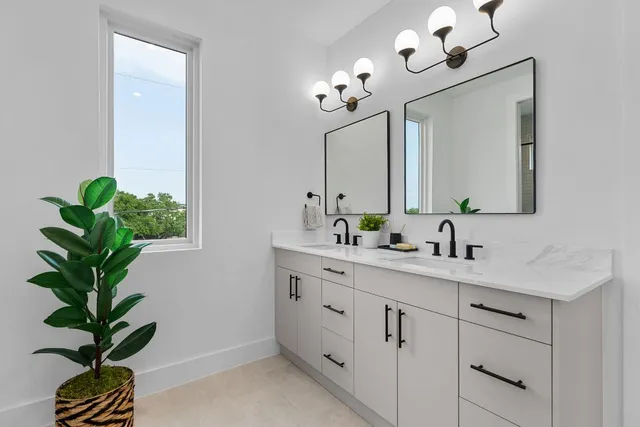 an empty room with a window and a ceiling fan