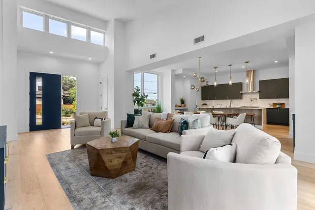 a living room with furniture and a view of kitchen