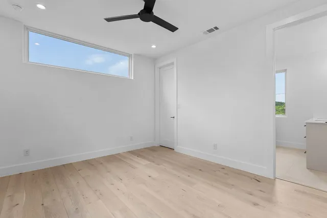 a view of empty room with wooden floor
