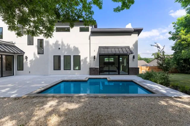 a view of swimming pool with outdoor seating