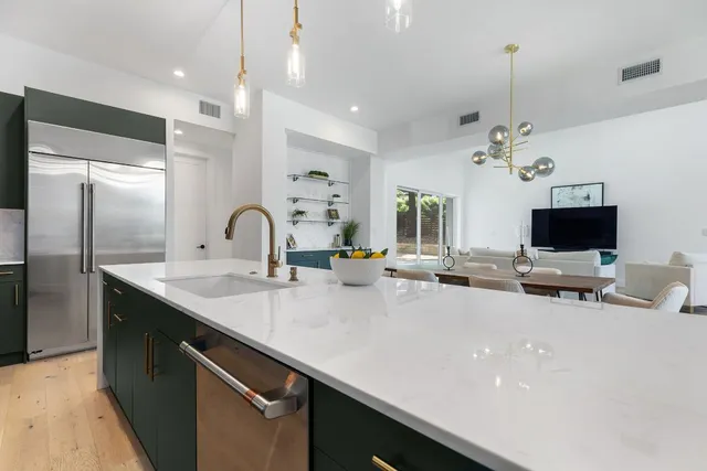 an aerial view of a house with a garden and a building