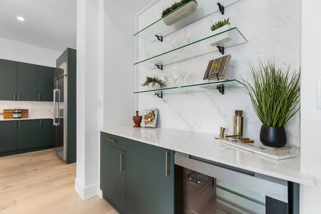 a kitchen with stainless steel appliances a sink and a refrigerator