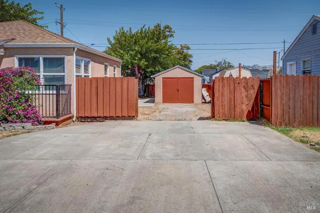 a view of a house with backyard and potted plants