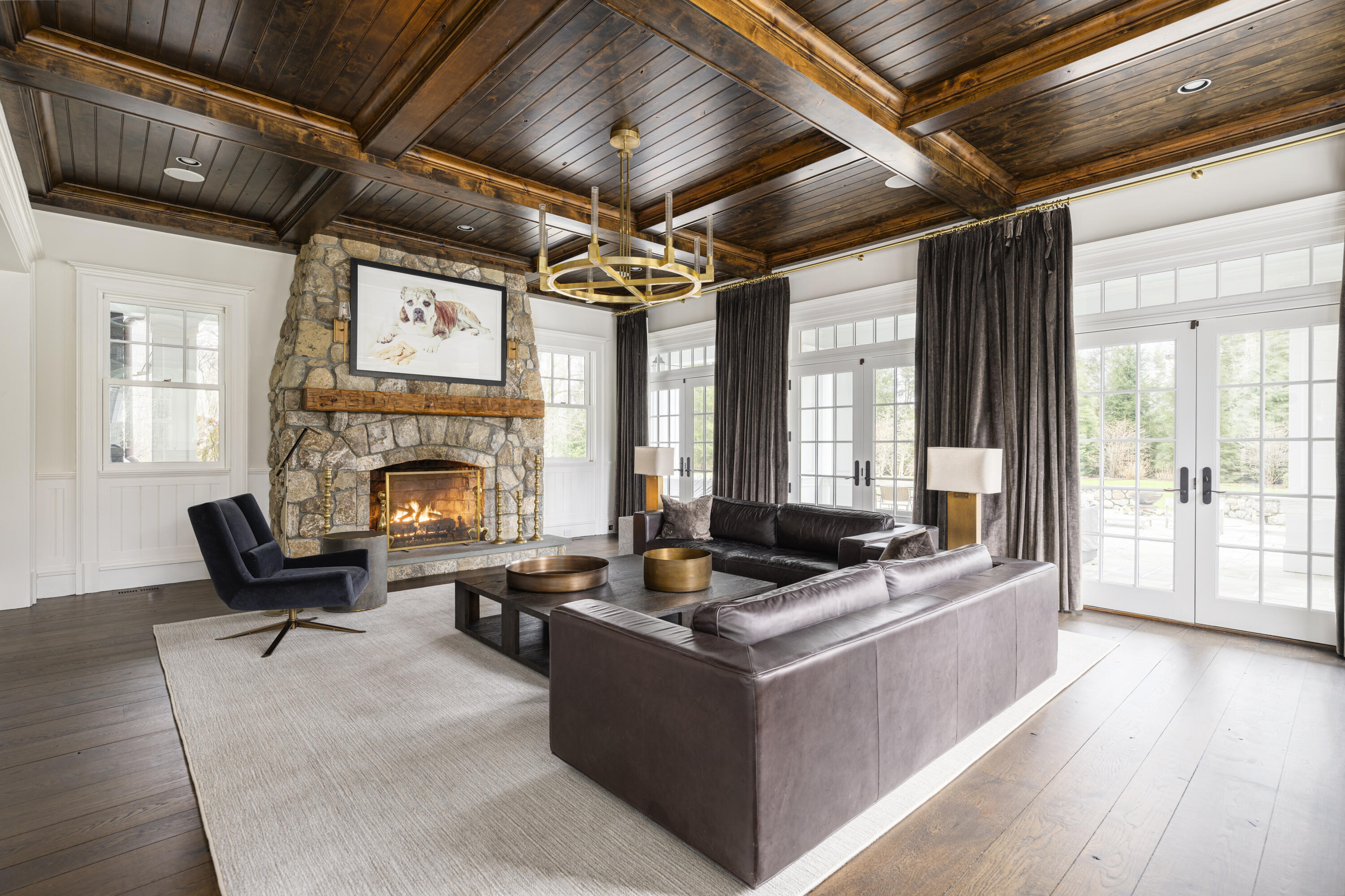 727 Smith Ridge Road New Canaan, CT 06840 - Photo 13 of 31 a living room with furniture a fireplace and a floor to ceiling window