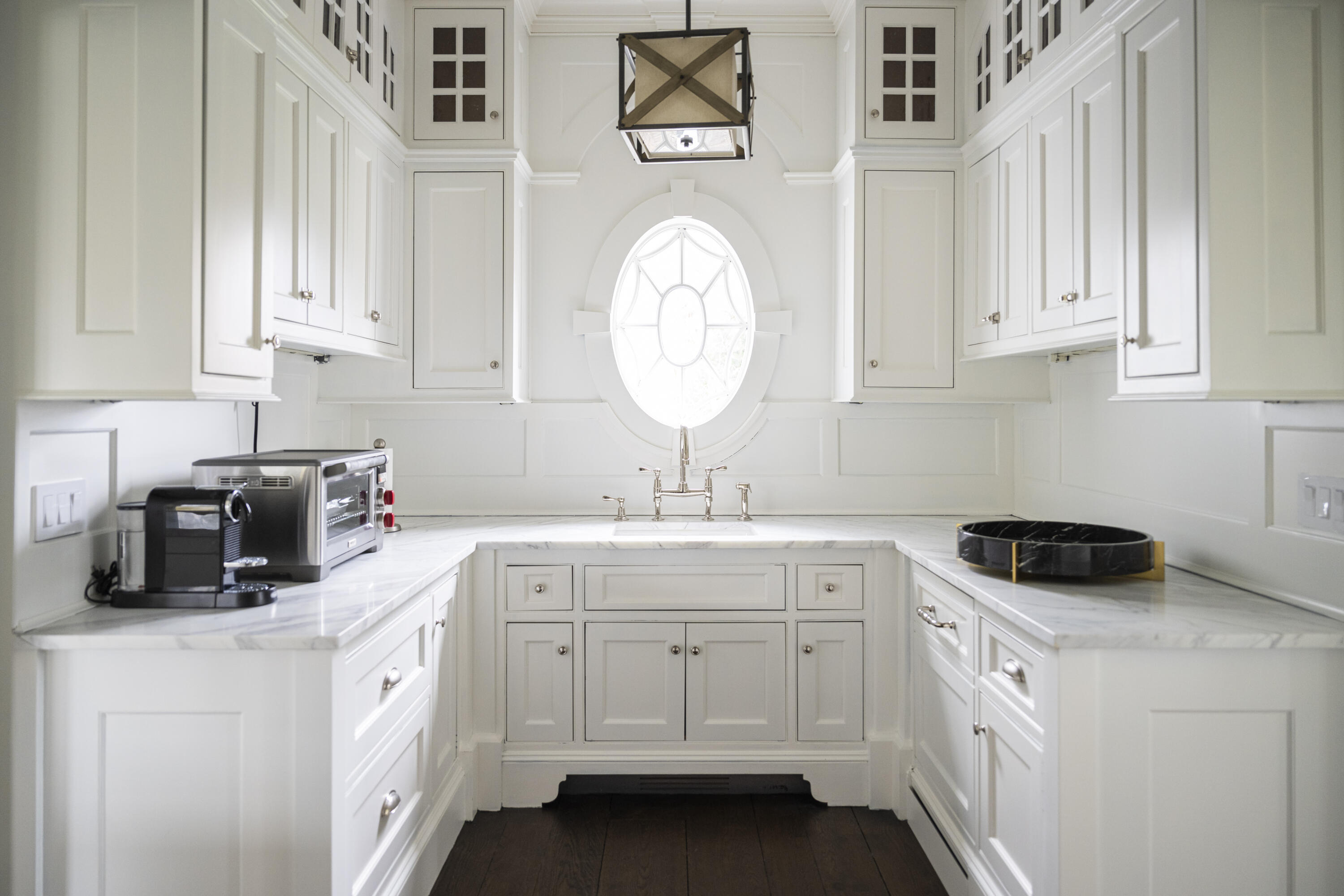 727 Smith Ridge Road New Canaan, CT 06840 - Photo 14 of 31 a kitchen with white cabinets and white appliances
