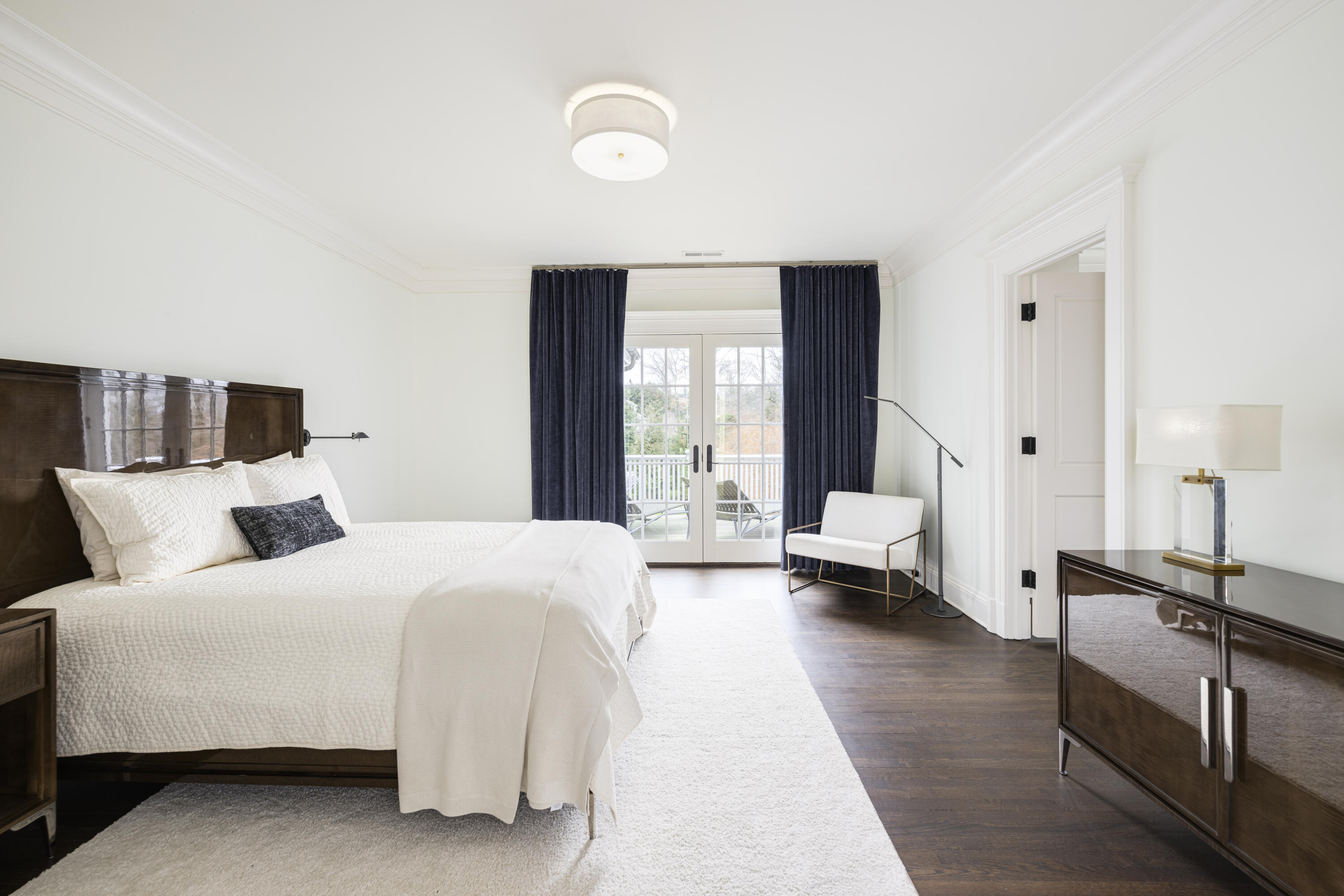 727 Smith Ridge Road New Canaan, CT 06840 - Photo 20 of 31 a spacious bedroom with a large bed and a couch