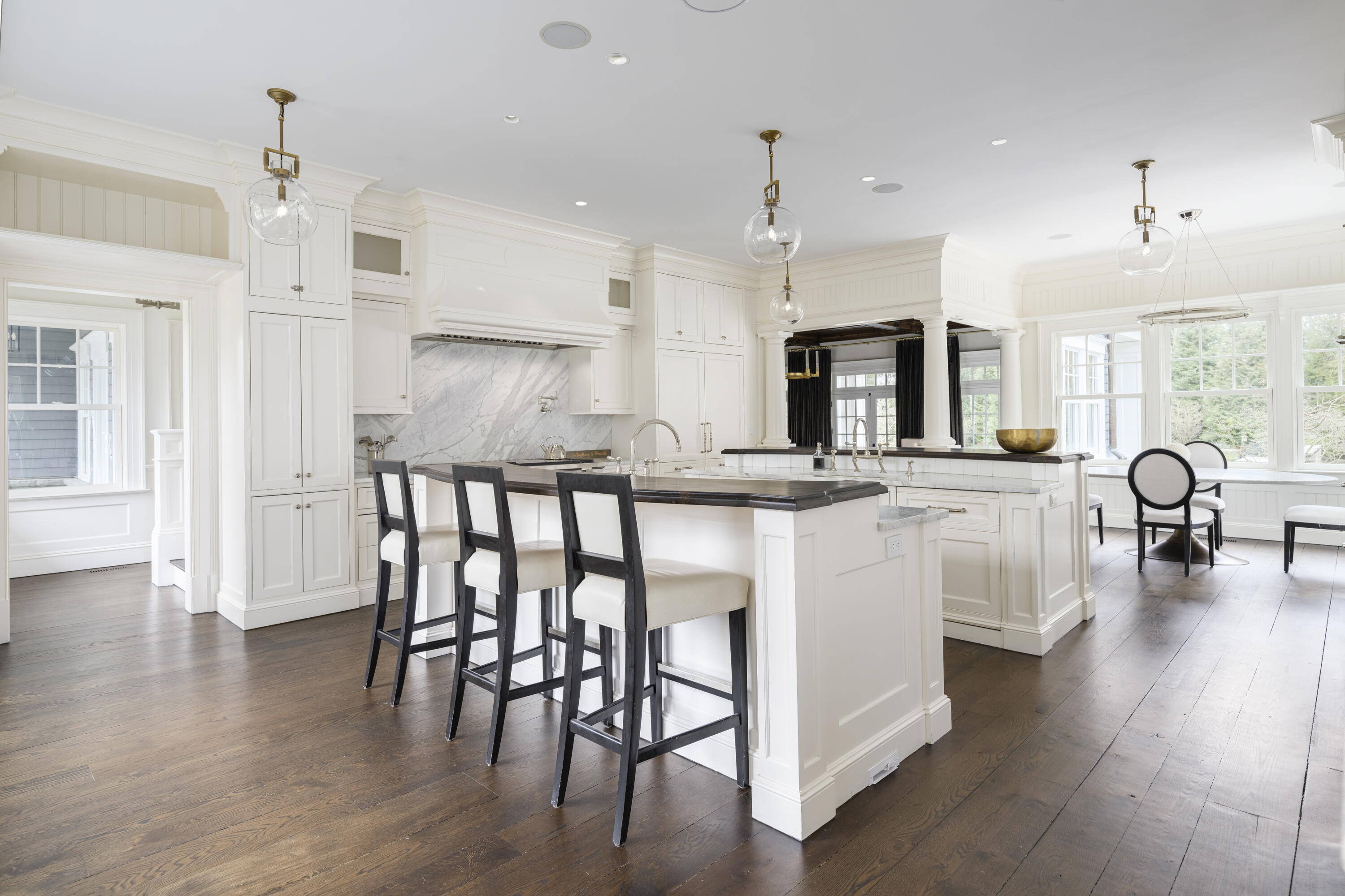 727 Smith Ridge Road New Canaan, CT 06840 - Photo 9 of 31 a kitchen with stainless steel appliances granite countertop a stove a sink a refrigerator and a dining table with wooden floor