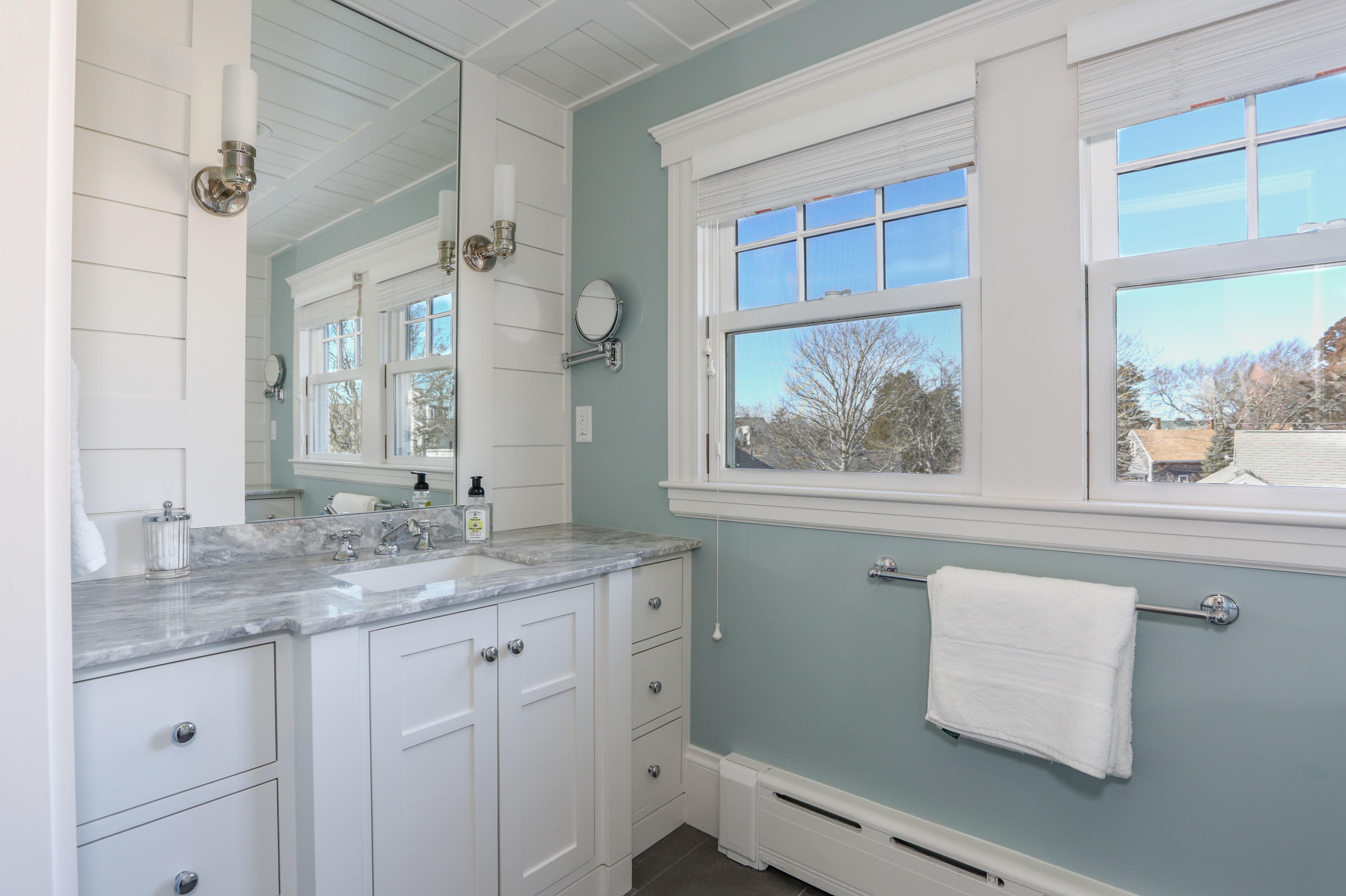 22 Mill Pond Road Chatham, MA 02633 - Photo 24 of 35 a bathroom with a granite countertop sink a large mirror a vanity and a window