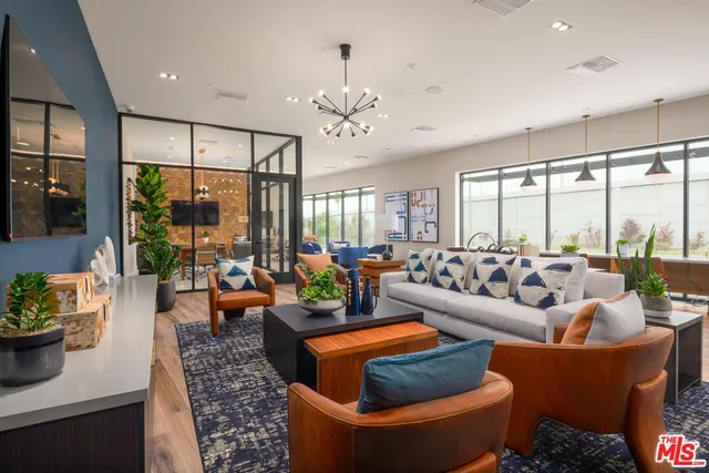 a living room with fireplace furniture and a large window