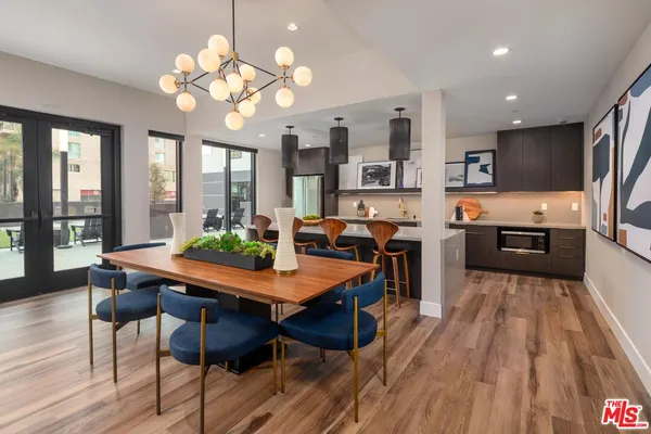 a view of a dining room with furniture large window and wooden floor