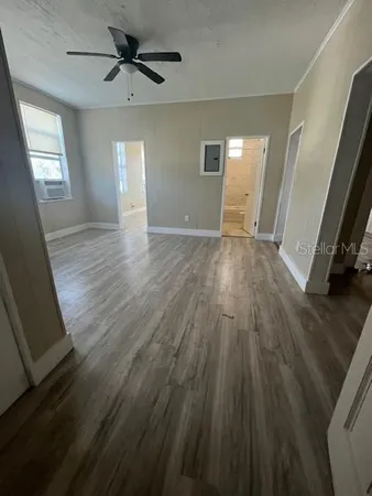 wooden floor in an empty room with a window
