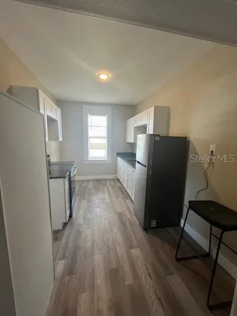 a view of kitchen with furniture and wooden floor