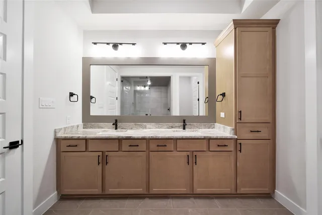 a bathroom with a double vanity sink and mirror