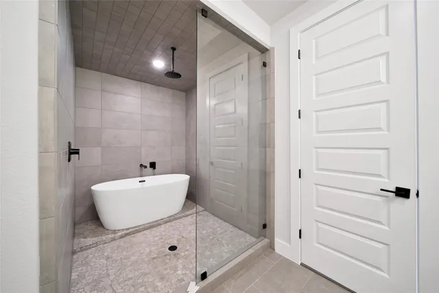 a bathroom with a bathtub and shower