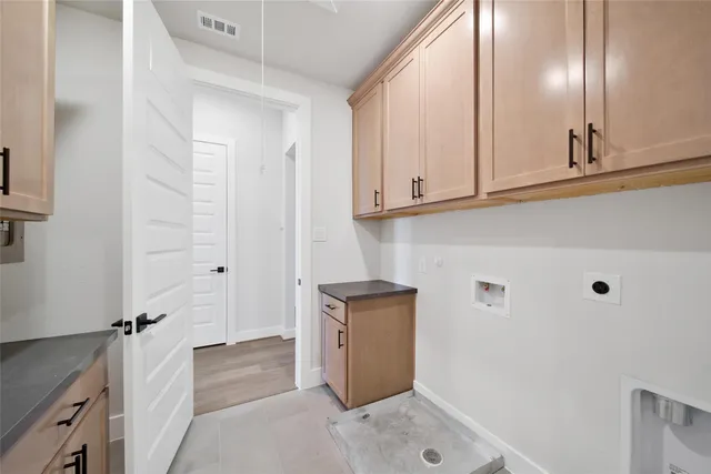 a view of cabinets with washer and dryer