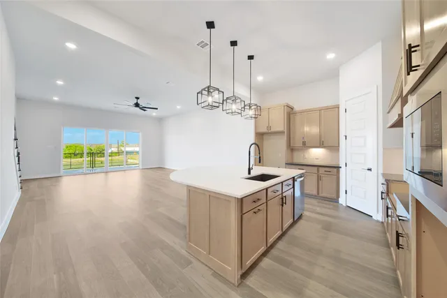 a kitchen with stove and wooden floor