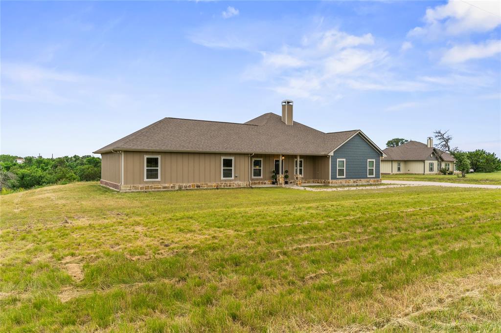 139 Kriston Lane Springtown, TX 76082 - Photo 3 of 39 Single-story residence featuring a brown shingle roof and a stone and siding exterior
