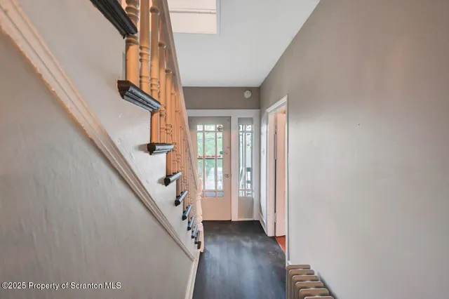 a view of a room with wooden floor and chandelier
