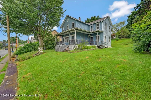 front view of a house with a garden