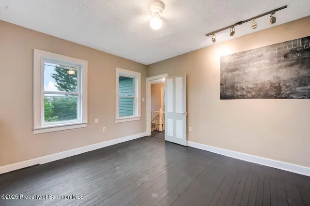 a view of a field of grass and trees