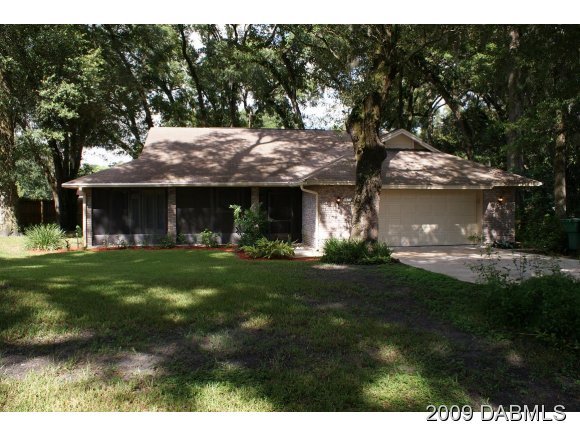 2671 Spring Court DeLand, FL 32720 - Photo 1 of 11 a front view of a house with a garden