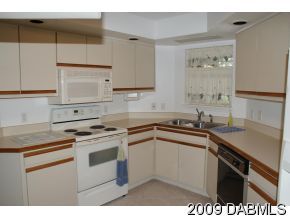 2671 Spring Court DeLand, FL 32720 - Photo 3 of 11 a kitchen with stainless steel appliances granite countertop a sink stove and cabinets