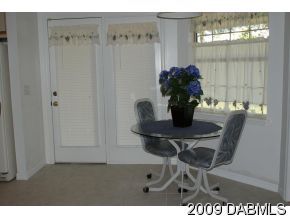 2671 Spring Court DeLand, FL 32720 - Photo 4 of 11 a dining room with furniture and wooden floor