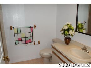 2671 Spring Court DeLand, FL 32720 - Photo 10 of 11 a bathroom with a toilet sink and mirror