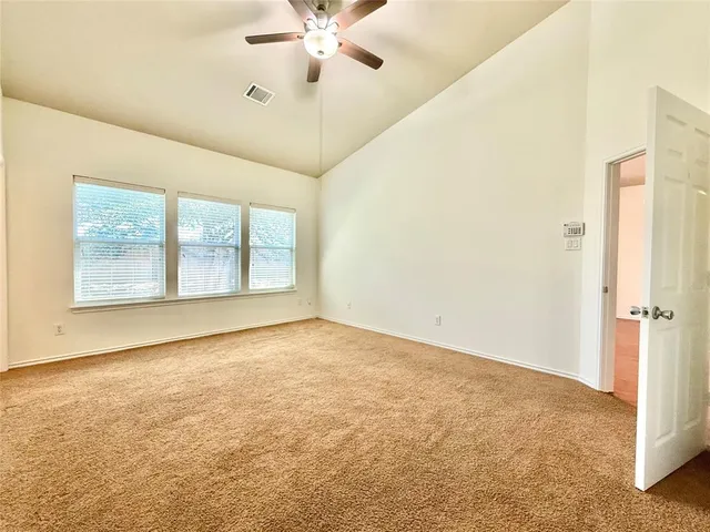 an empty room with a empty space and a ceiling fan