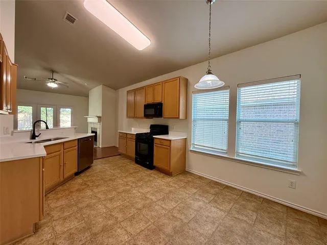 a kitchen with stove a sink and a refrigerator