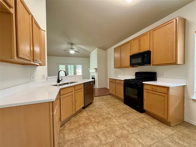 a kitchen with stainless steel appliances granite countertop a sink stove and microwave