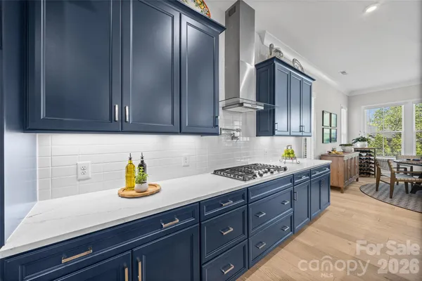 a kitchen with stainless steel appliances granite countertop a sink a stove and cabinets