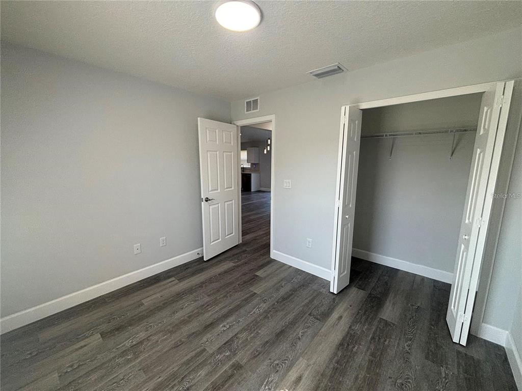 13187 Southwest 103rd Place Dunnellon, FL 34432 - Photo 14 of 49 an empty room with wooden floor and closet