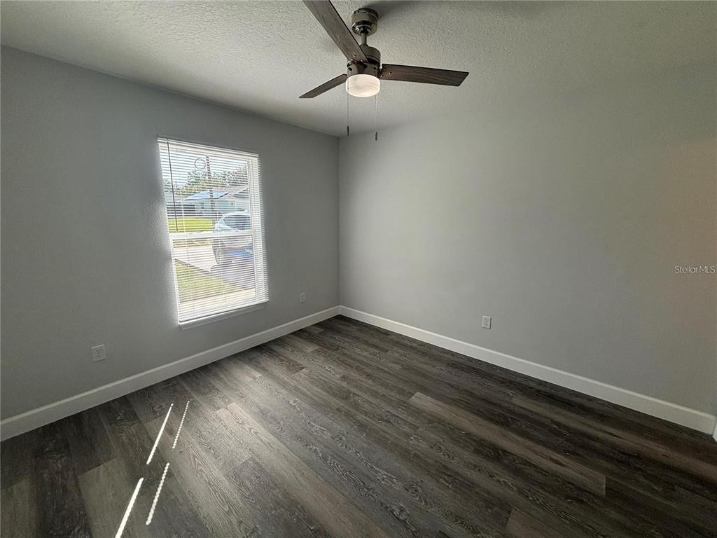 13187 Southwest 103rd Place Dunnellon, FL 34432 - Photo 22 of 49 wooden floor in an empty room with a window