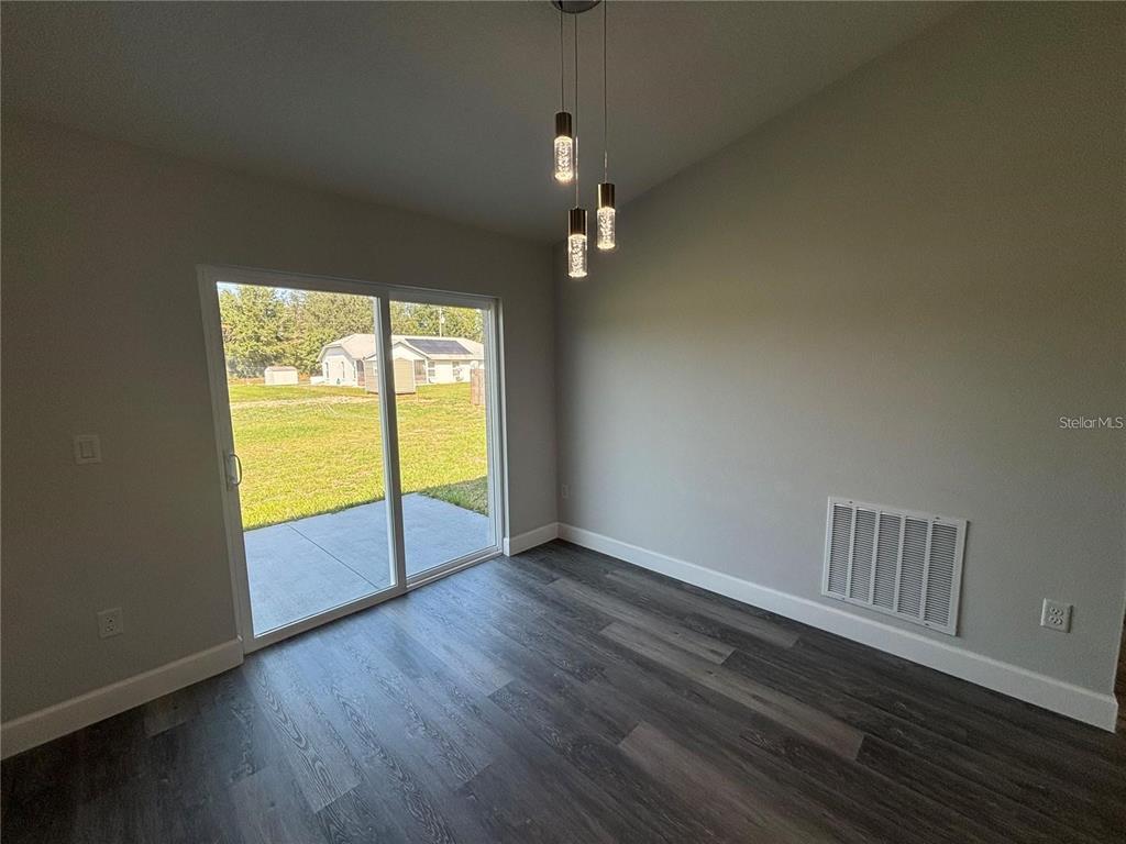 13187 Southwest 103rd Place Dunnellon, FL 34432 - Photo 27 of 49 an empty room with wooden floor and windows