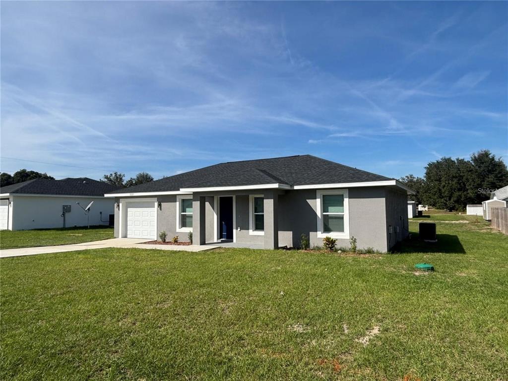 13187 Southwest 103rd Place Dunnellon, FL 34432 - Photo 30 of 49 a view of a house with a big yard and large trees
