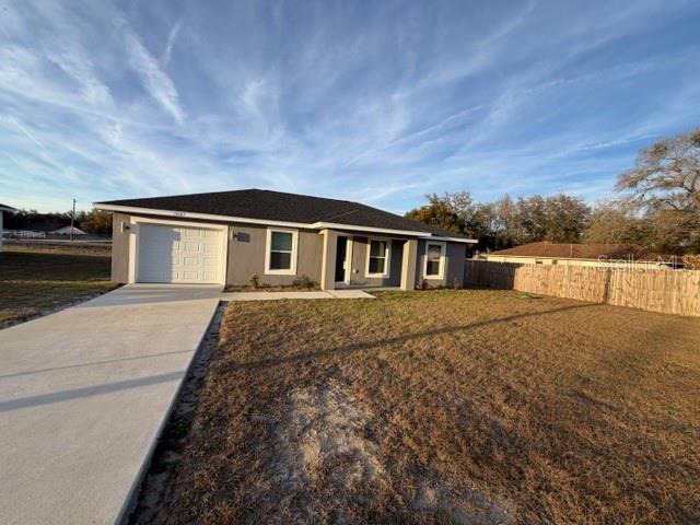 13187 Southwest 103rd Place Dunnellon, FL 34432 - Photo 3 of 49 a front view of a house with a yard