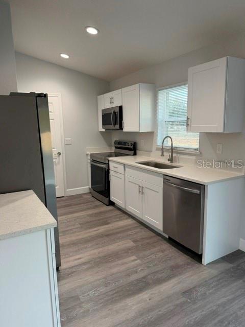 13187 Southwest 103rd Place Dunnellon, FL 34432 - Photo 37 of 49 a kitchen with a sink a stove and refrigerator