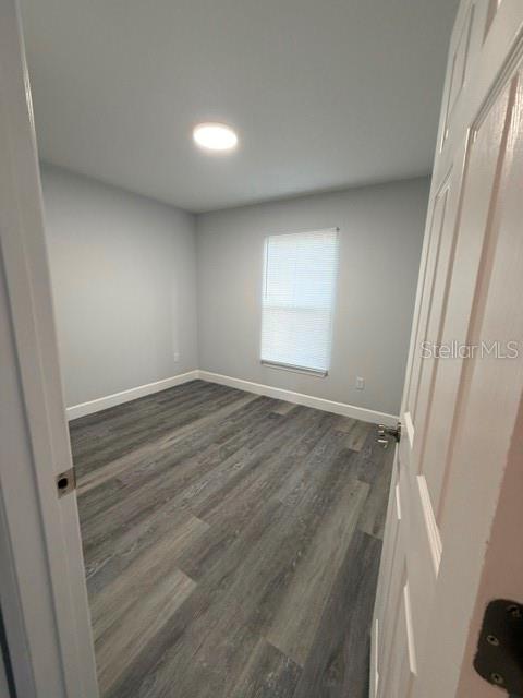 13187 Southwest 103rd Place Dunnellon, FL 34432 - Photo 42 of 49 an empty room with wooden floor and windows
