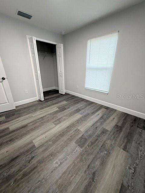 13187 Southwest 103rd Place Dunnellon, FL 34432 - Photo 45 of 49 an empty room with wooden floor and windows
