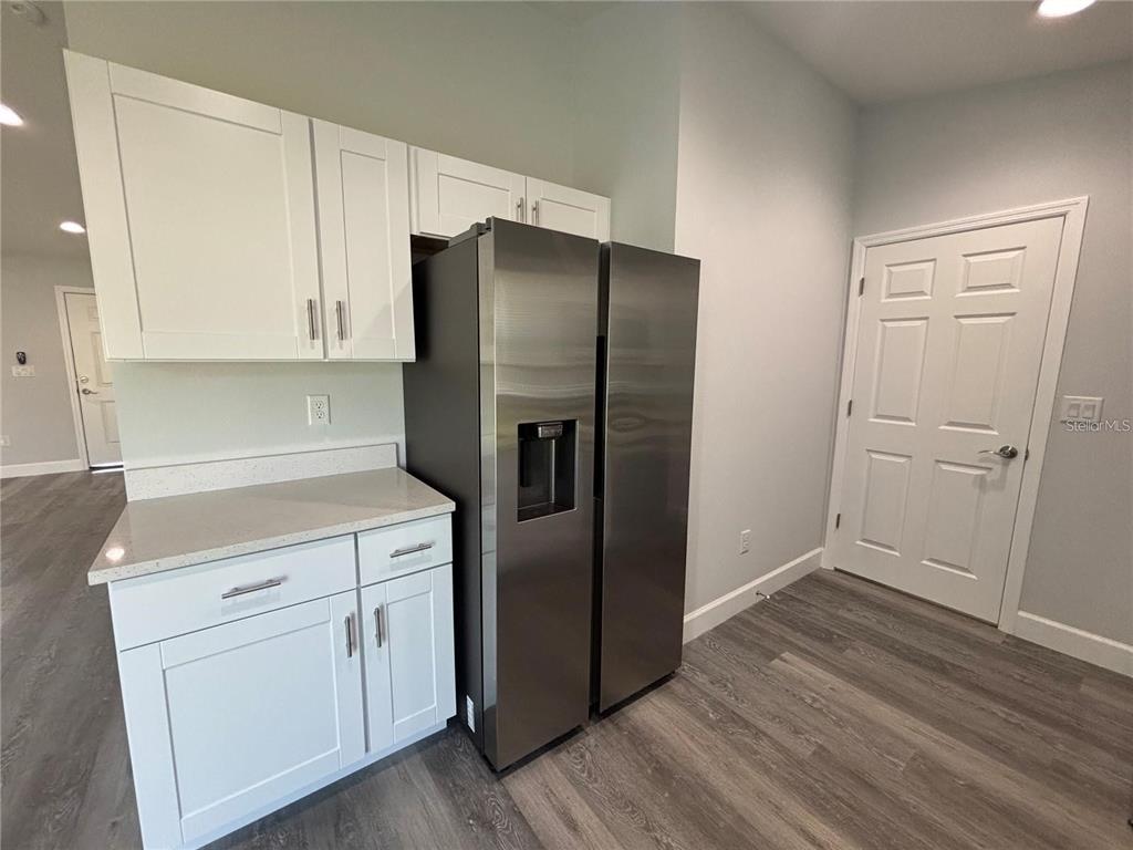 13187 Southwest 103rd Place Dunnellon, FL 34432 - Photo 6 of 49 a kitchen with a refrigerator sink and cabinets