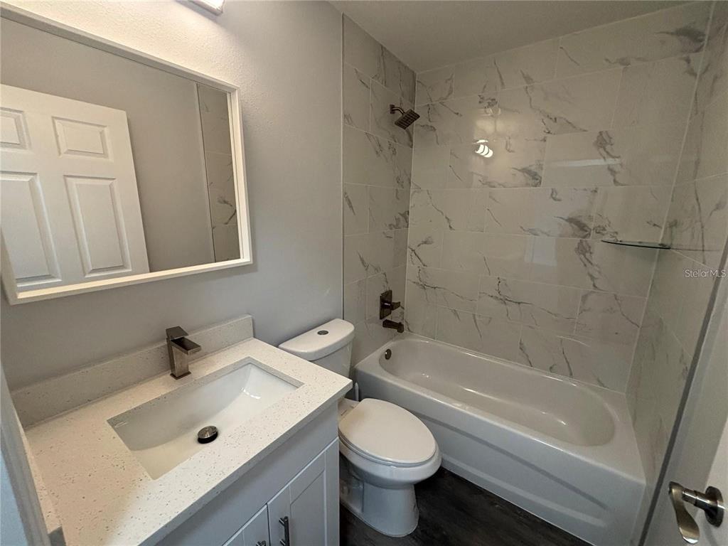 13187 Southwest 103rd Place Dunnellon, FL 34432 - Photo 7 of 49 a bathroom with a sink a toilet and shower