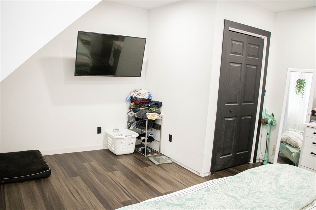 85-87 Slater Street Webster, MA 01570 - Photo 7 of 41 a bedroom with a bed and a flat screen tv