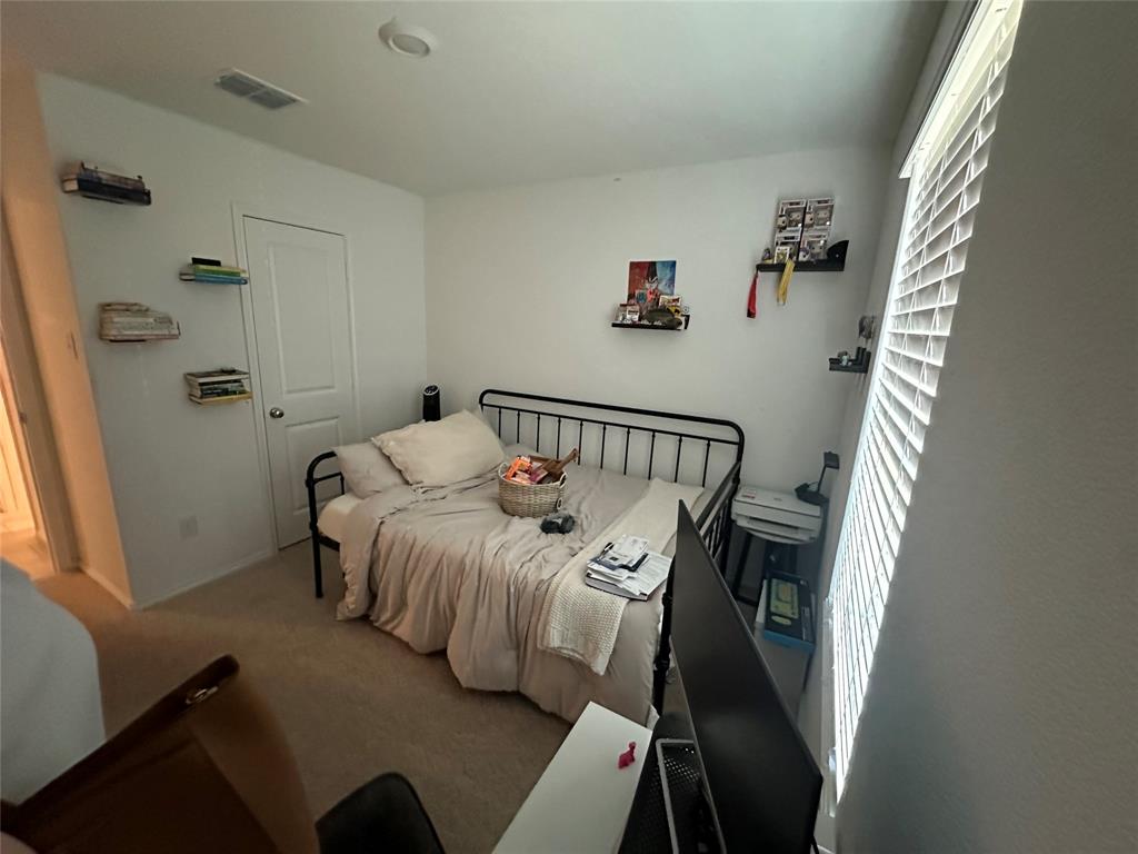 2928 Dora Drive Fort Worth, TX 76119 - Photo 13 of 15 a bedroom with a bed and wooden floor