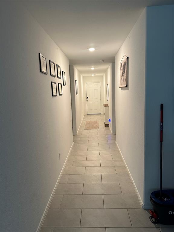 2928 Dora Drive Fort Worth, TX 76119 - Photo 2 of 15 a view of a hallway with paintings on the wall