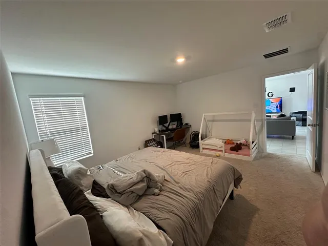 a bedroom with a bed and furniture