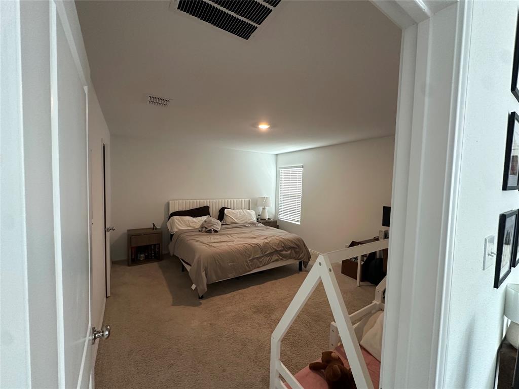 2928 Dora Drive Fort Worth, TX 76119 - Photo 5 of 15 a bedroom with a bed and cabinets